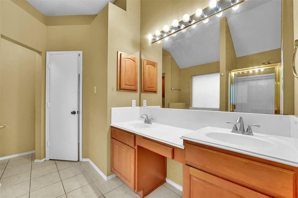 4507 Stones River Road Grand Prairie, TX 75052 - Photo 22 of 28 a bathroom with a sink and a mirror