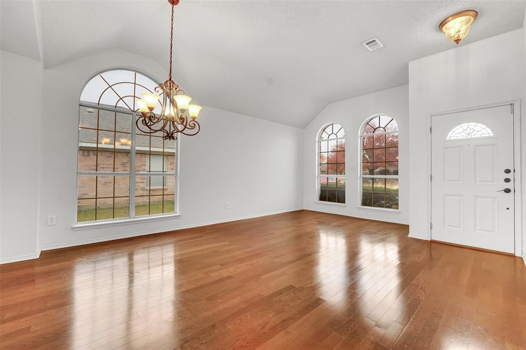 4507 Stones River Road Grand Prairie, TX 75052 - Photo 5 of 28 a view of an empty room with wooden floor and a window