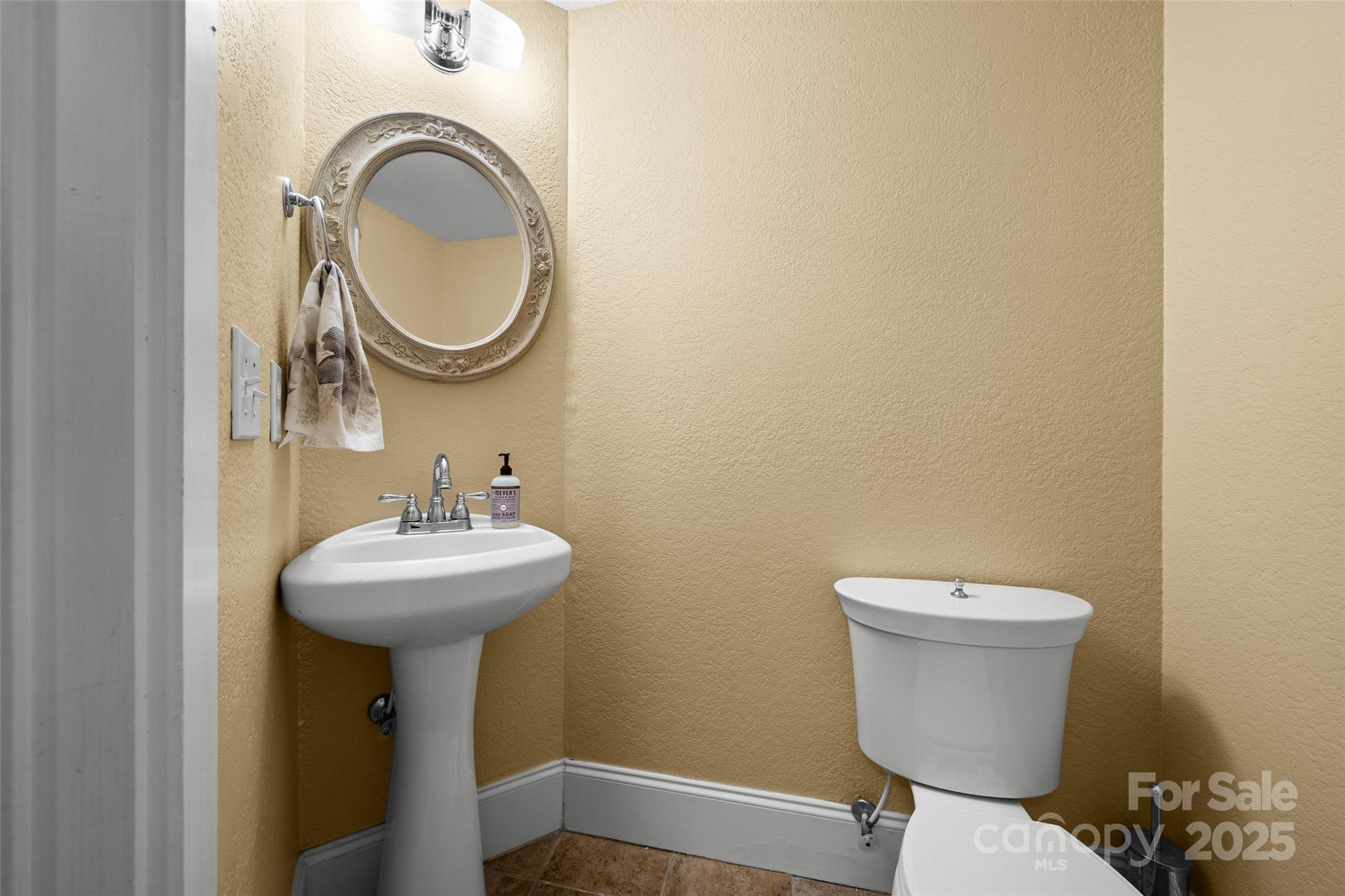 571 Terrys Gap Road Fletcher, NC 28732 - Photo 23 of 44 a bathroom with a sink mirror and toilet