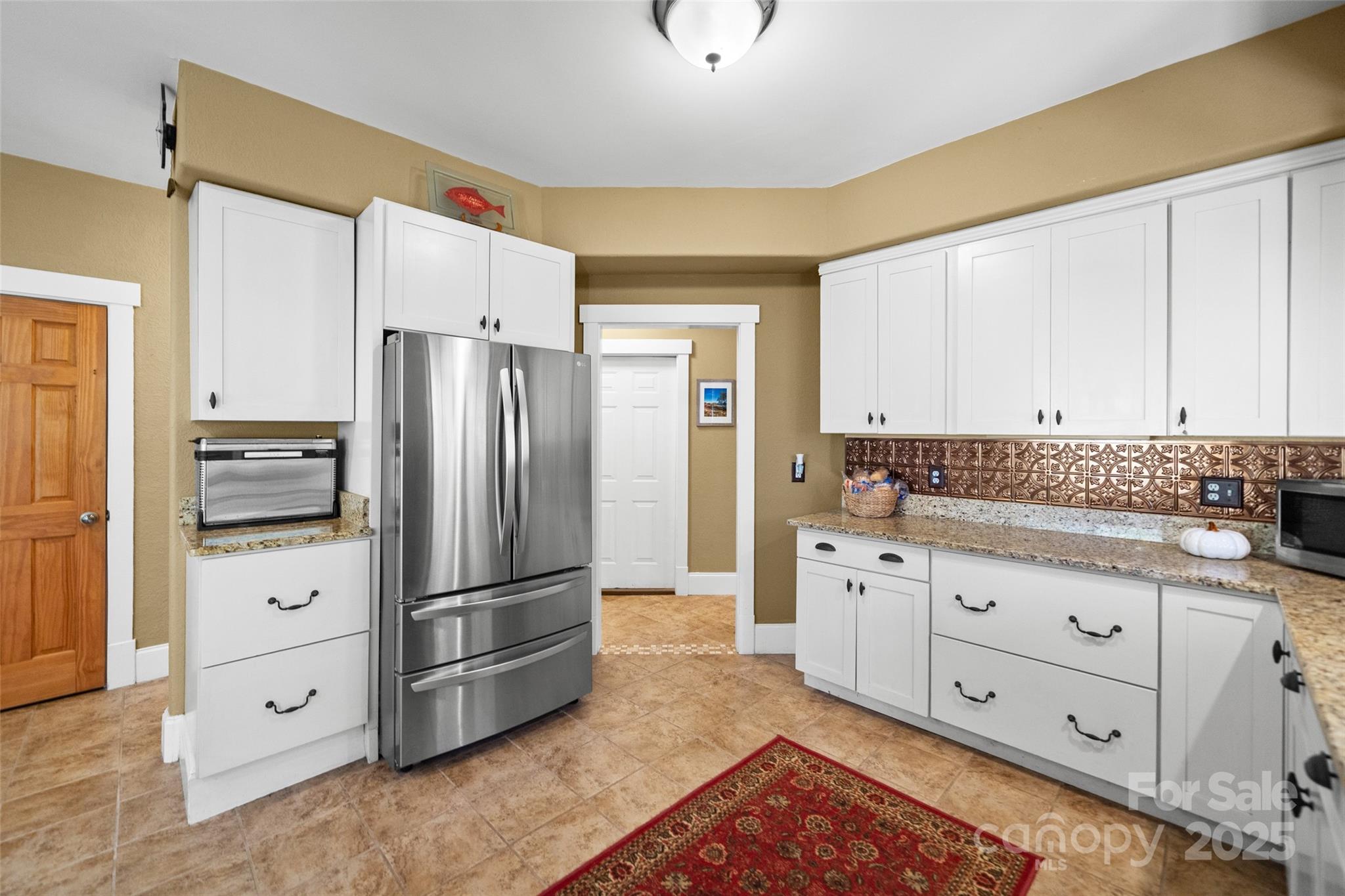 571 Terrys Gap Road Fletcher, NC 28732 - Photo 8 of 44 a kitchen with granite countertop white cabinets and stainless steel appliances