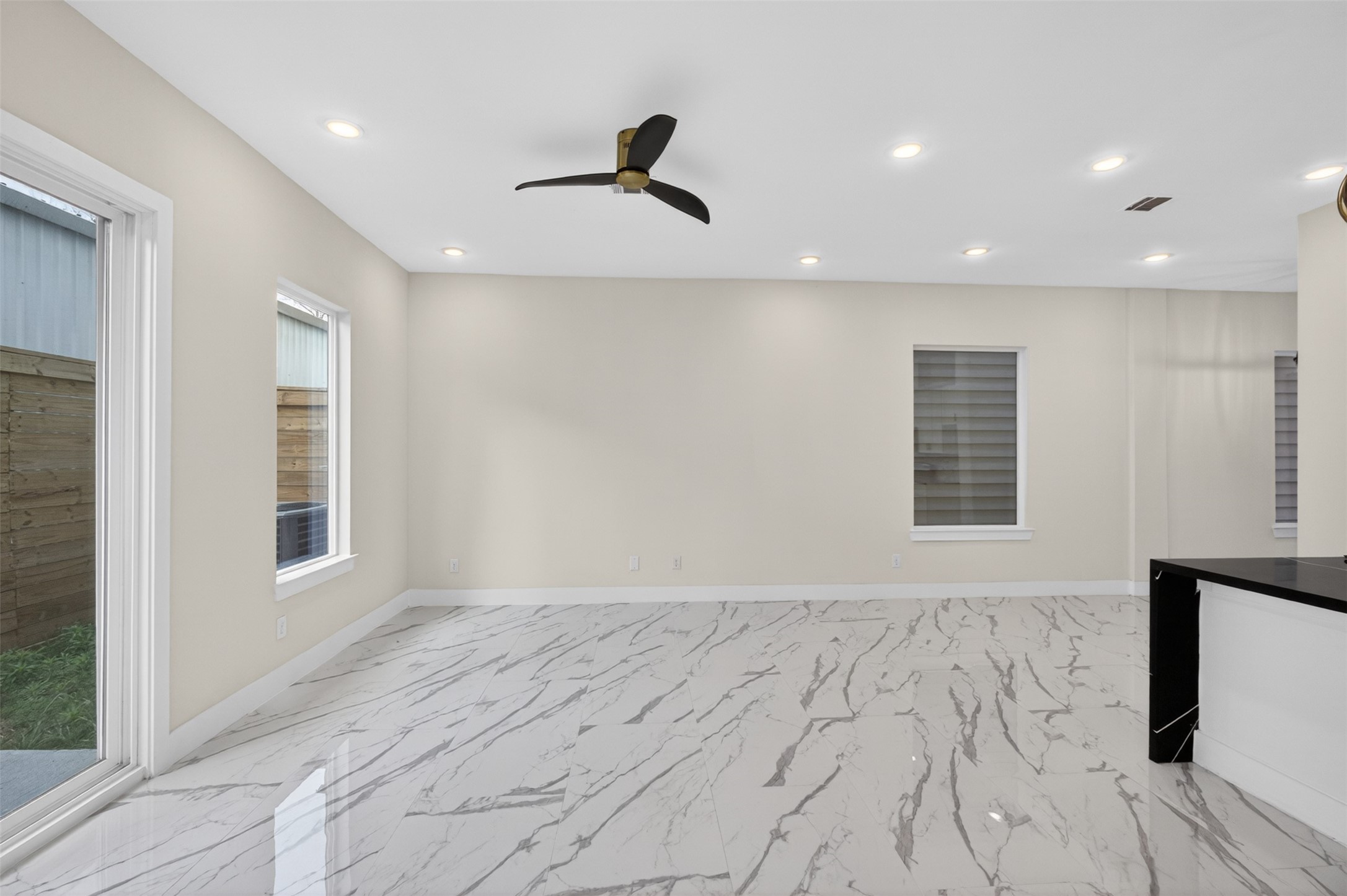 5906 St Augustine Street, Unit F Houston, TX 77021 - Photo 10 of 34 Open living area with recessed lighting, a ceiling fan, and expansive marble-look flooring.