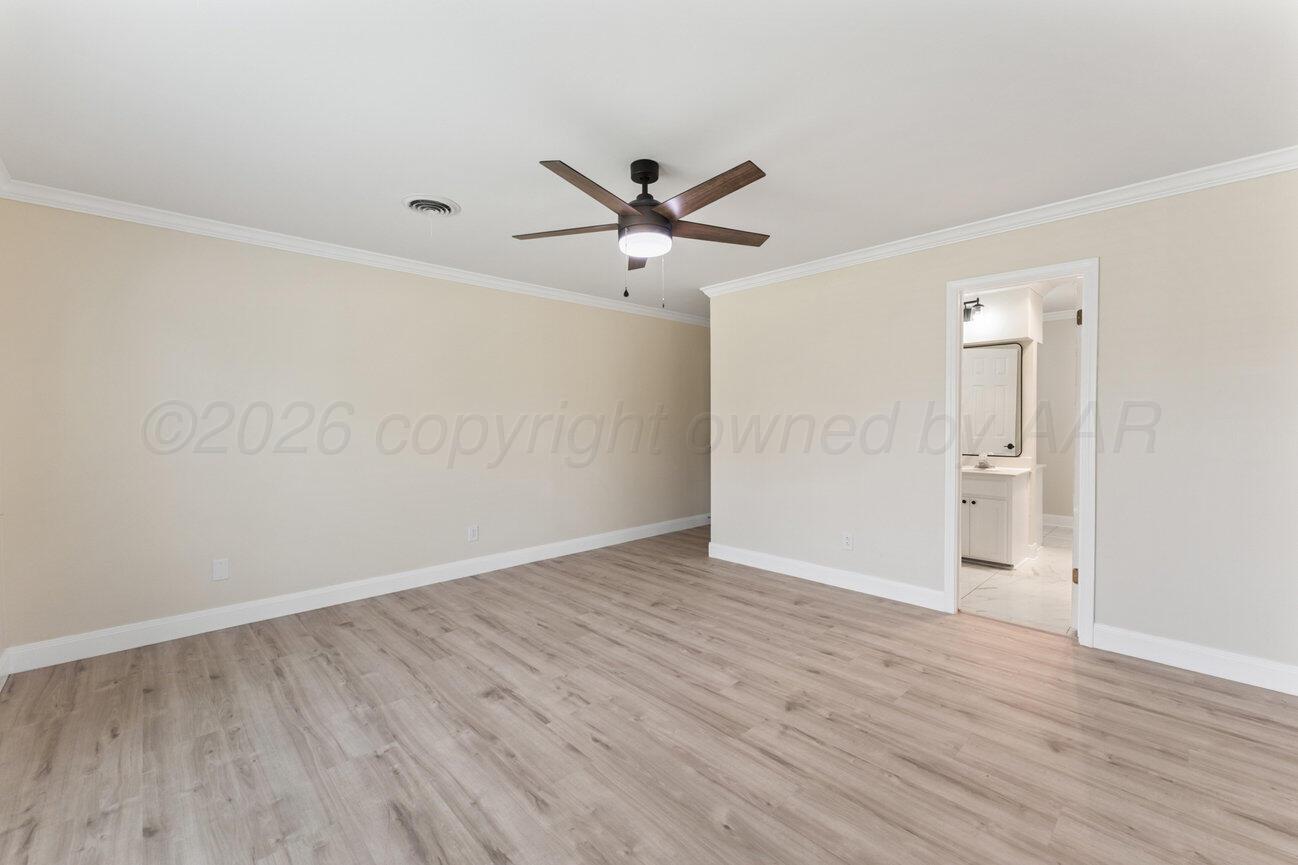 7204 Southwest 39th Avenue Amarillo, TX 79109 - Photo 26 of 51 an empty room with wooden floor and a ceiling fan