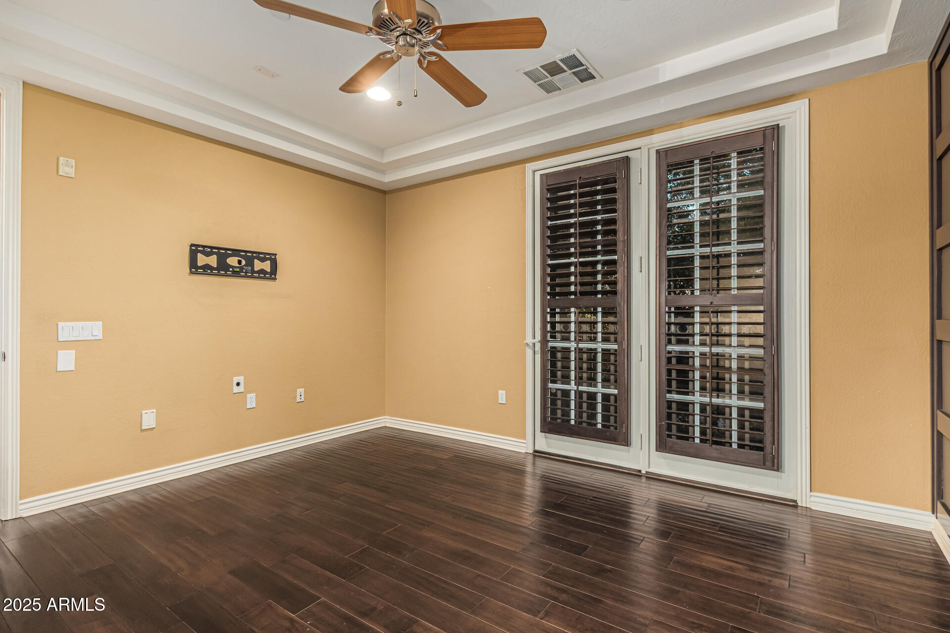 2482 East Roma Avenue Phoenix, AZ 85016 - Photo 19 of 39 a view of an empty room with wooden floor and a window