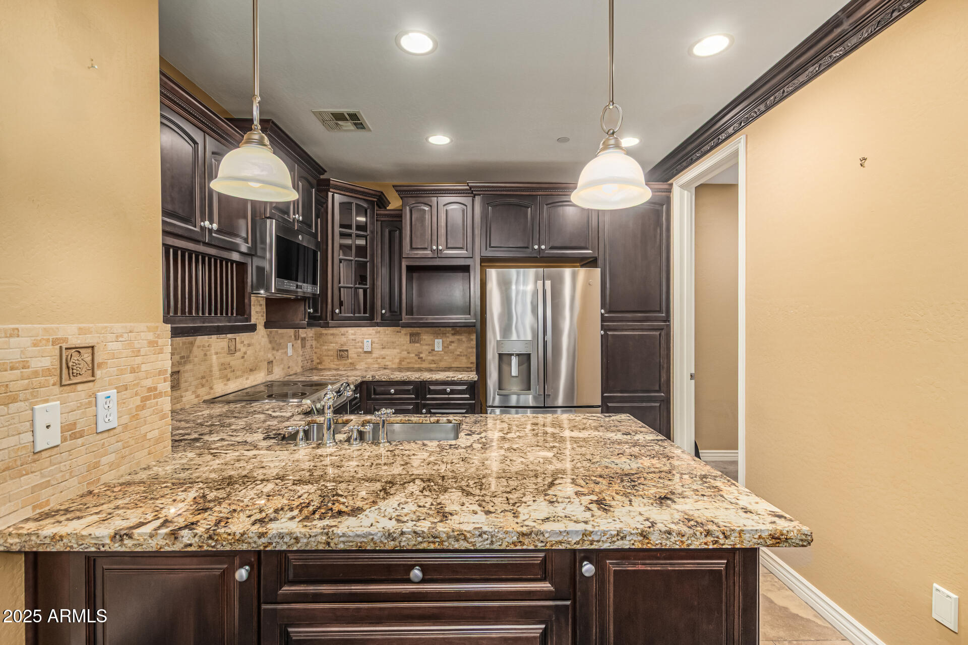 2482 East Roma Avenue Phoenix, AZ 85016 - Photo 5 of 39 a kitchen with stainless steel appliances granite countertop a sink and a refrigerator