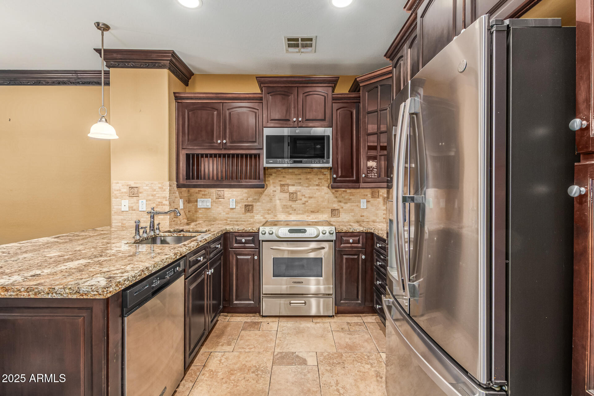 2482 East Roma Avenue Phoenix, AZ 85016 - Photo 7 of 39 a kitchen with stainless steel appliances granite countertop a refrigerator and a stove top oven