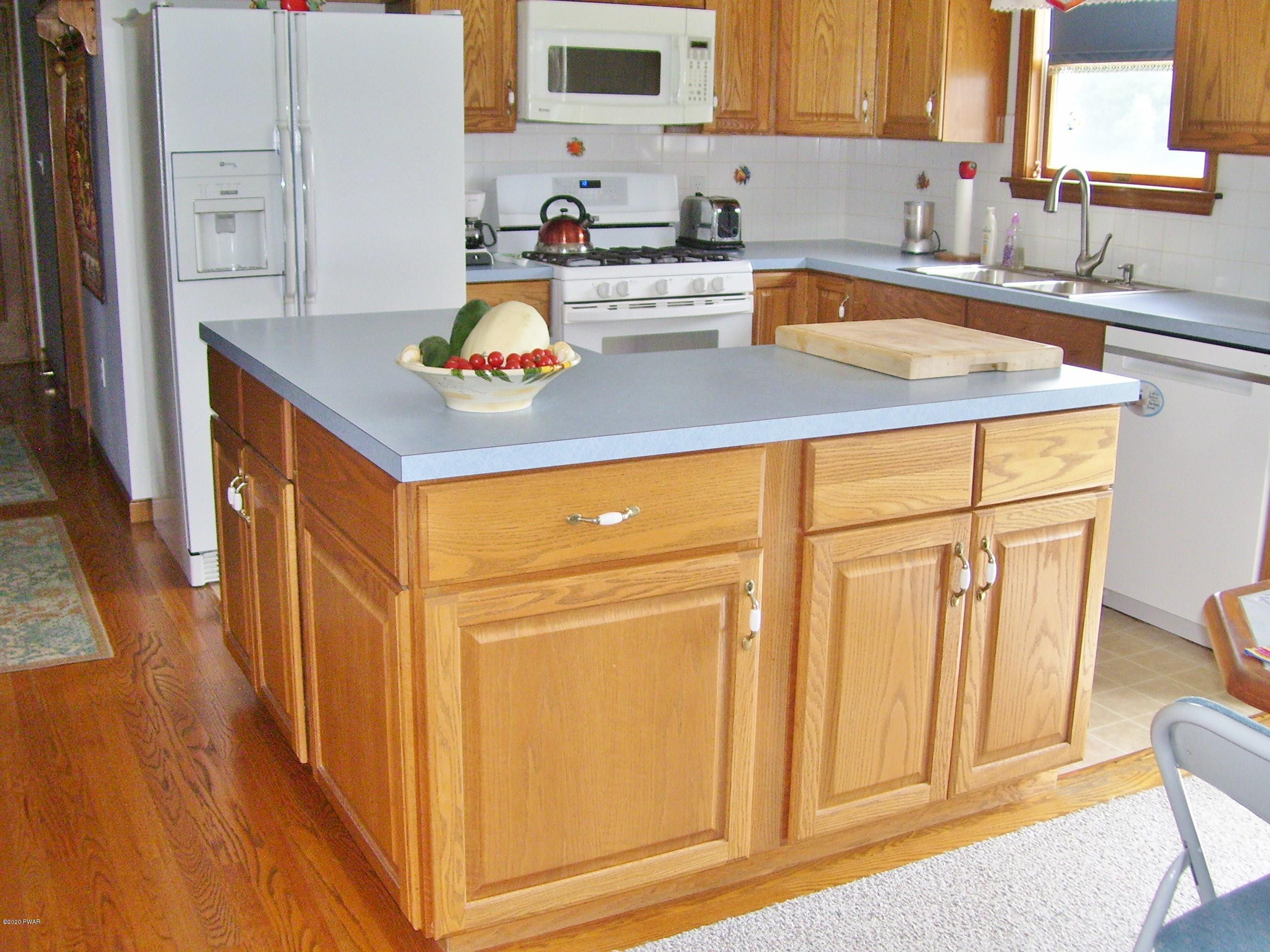 50 Layton Road Waymart, PA 18472 - Photo 16 of 61 a kitchen with stainless steel appliances granite countertop a sink and a refrigerator
