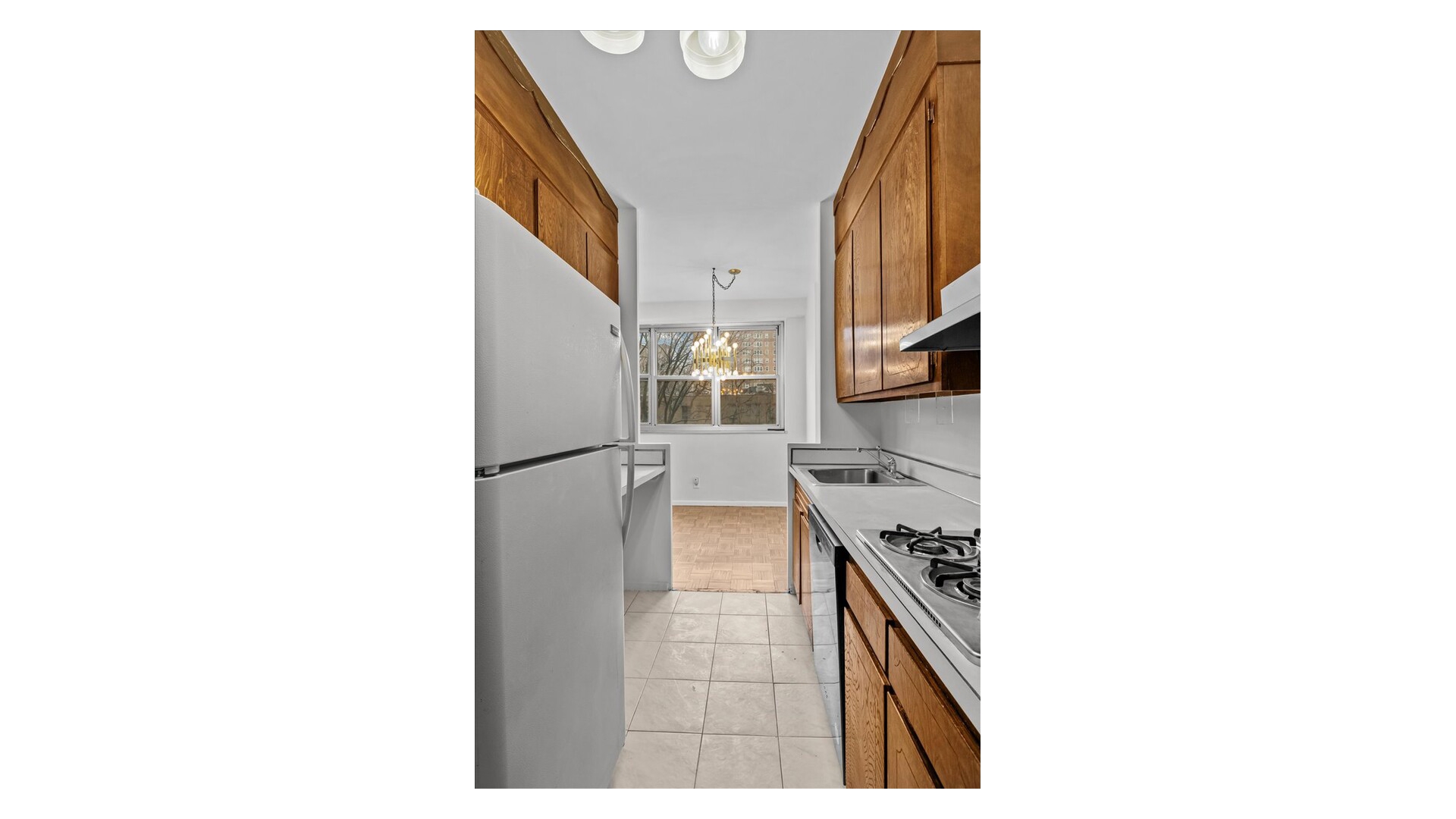 555 Kappock Street, Unit 4H Bronx, NY 10463 - Photo 5 of 16 a kitchen with a sink and a refrigerator