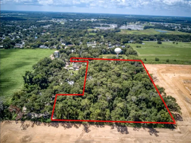 an aerial view of a houses and trees all around