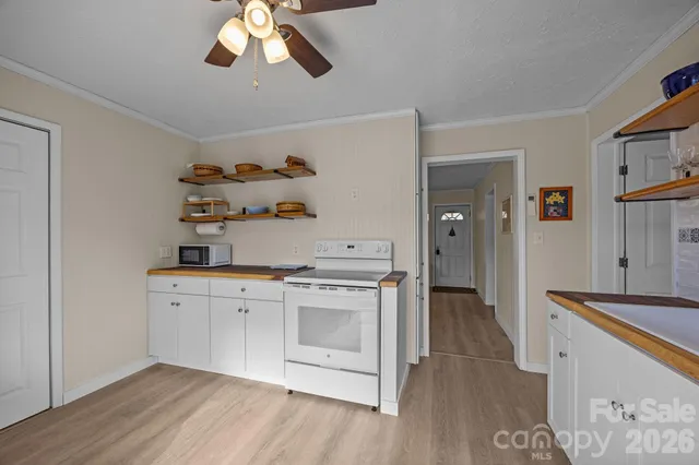 a kitchen with cabinets wooden floor and a sink