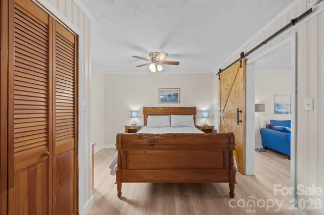 a bedroom with a bed and a chandelier