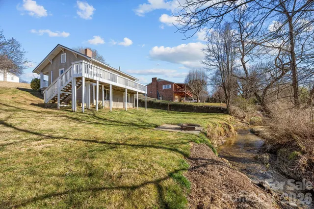 a large building with a big yard and large trees