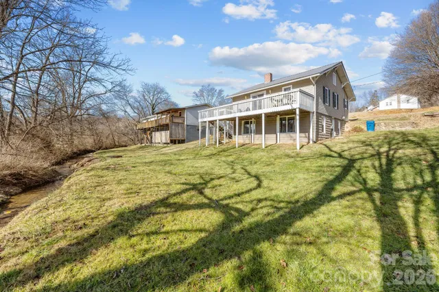 a view of a house with a yard and garage