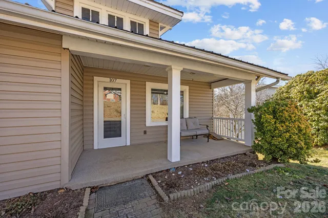 a view of a porch with furniture and yard