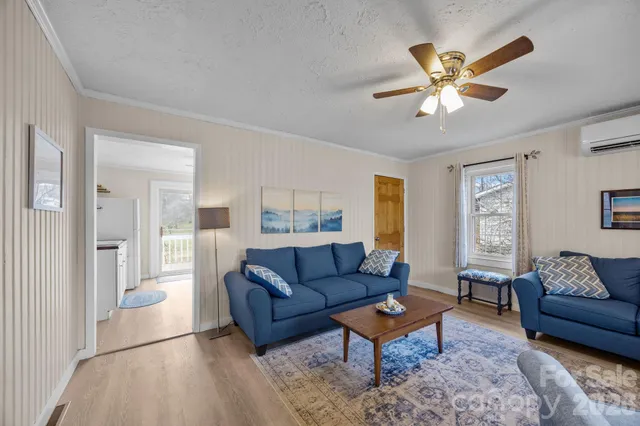 a living room with furniture a rug and a window