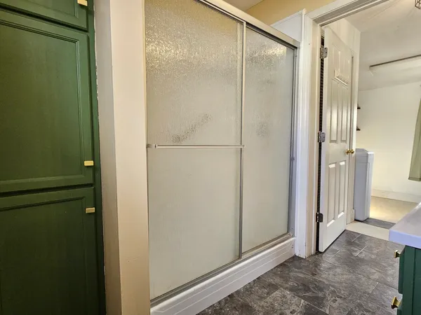 a bathroom with a glass shower door