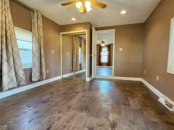 a view of a hallway with wooden floor