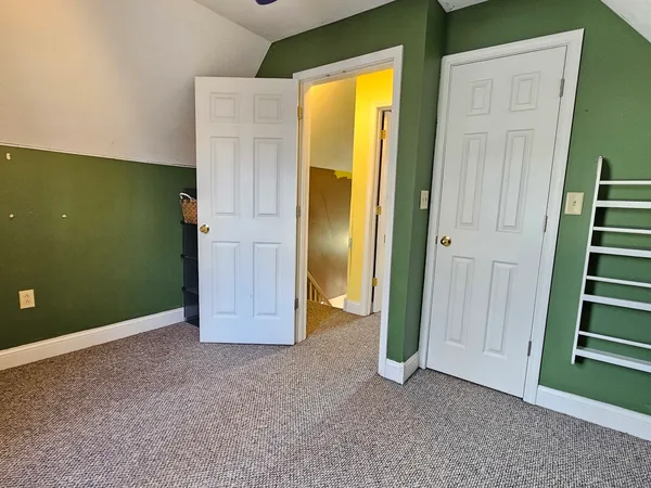 an empty room with windows and closet