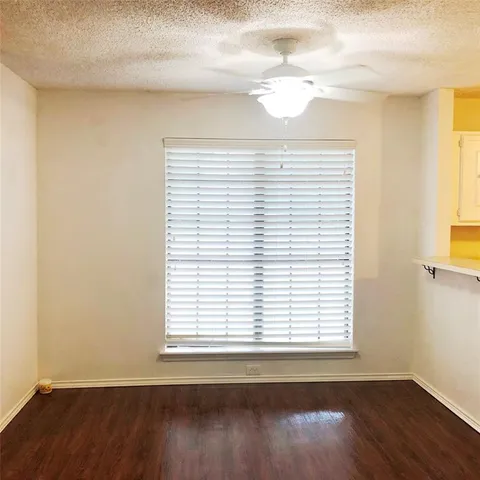 an empty room with wooden floor and a window