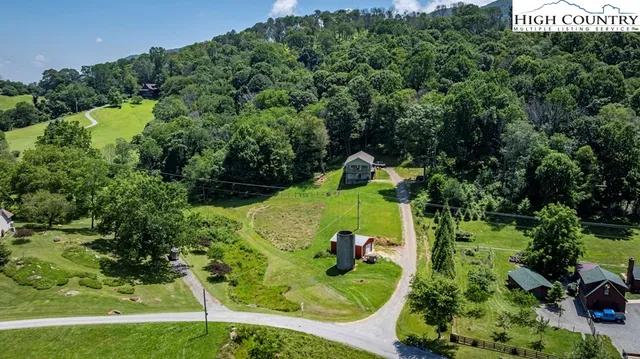 an aerial view of a house with a garden and trees