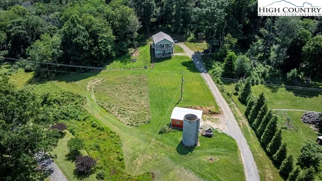 a view of a backyard with a garden and entertaining space