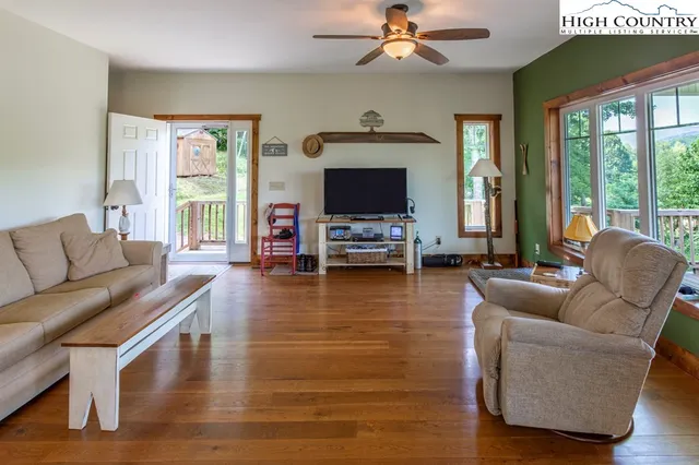 a living room with furniture fireplace and a large window