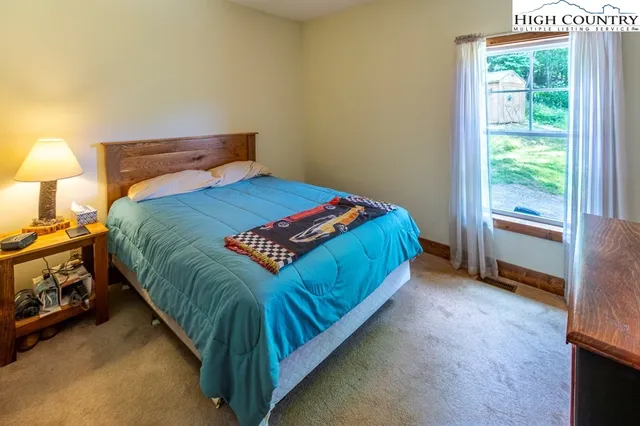 a bed sitting in a bedroom next to a window