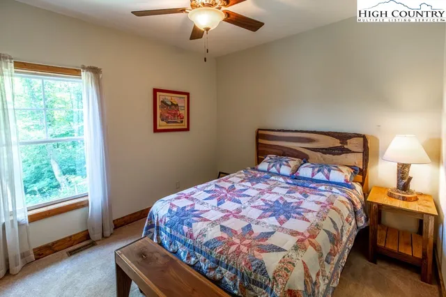 a bedroom with a bed and window