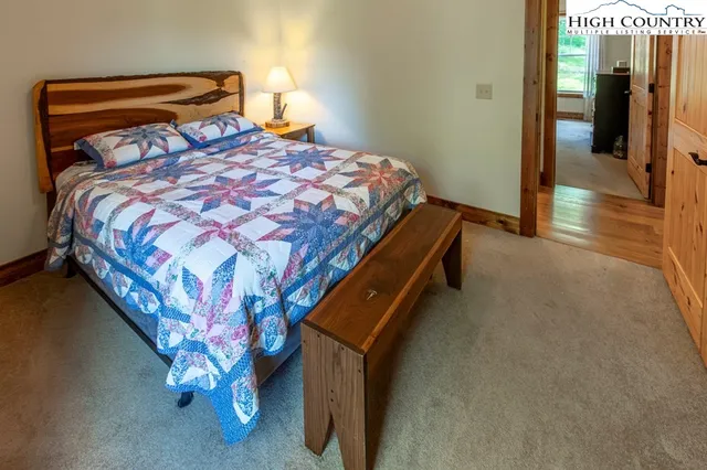 a bathroom with a granite countertop toilet sink and mirror