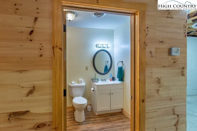 a bathroom with a toilet a sink and a mirror