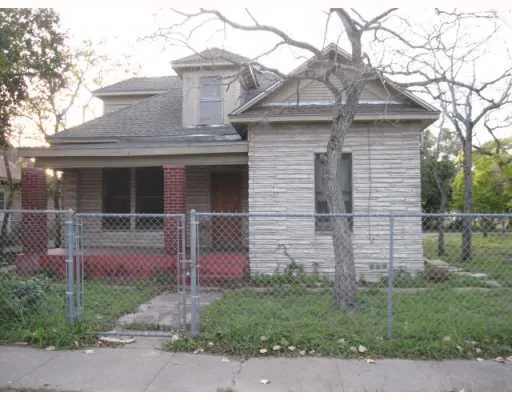 a front view of a house with plants