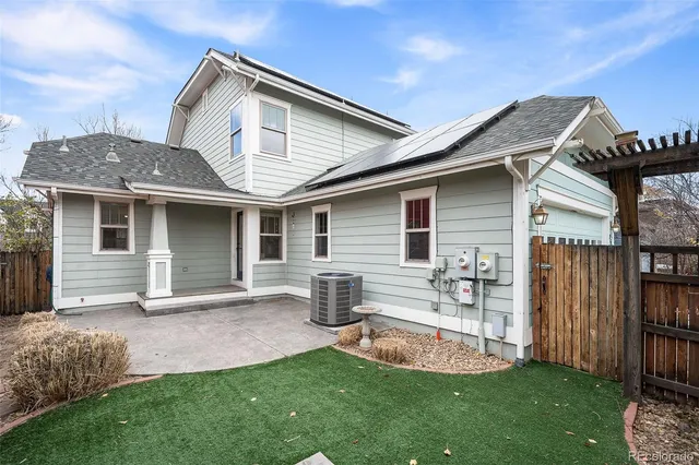 a front view of house with a garden and patio