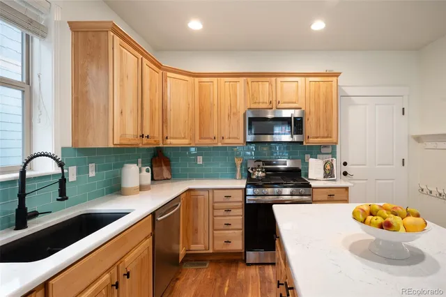 a kitchen with a sink a stove and cabinets