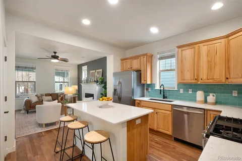 a kitchen with a sink a counter top space and stainless steel appliances