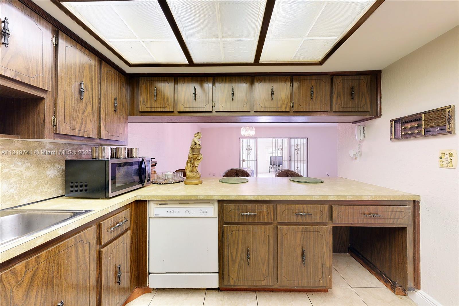 Hialeah Hialeah, FL 33014 - Photo 12 of 34 a kitchen with stainless steel appliances granite countertop a sink stove and cabinets