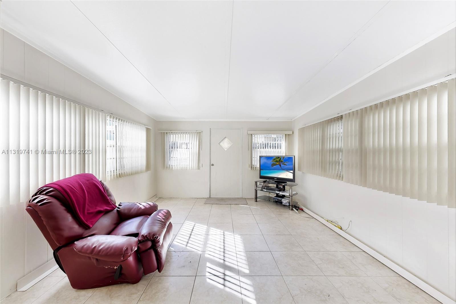 Hialeah Hialeah, FL 33014 - Photo 13 of 34 a living room with furniture and a large window
