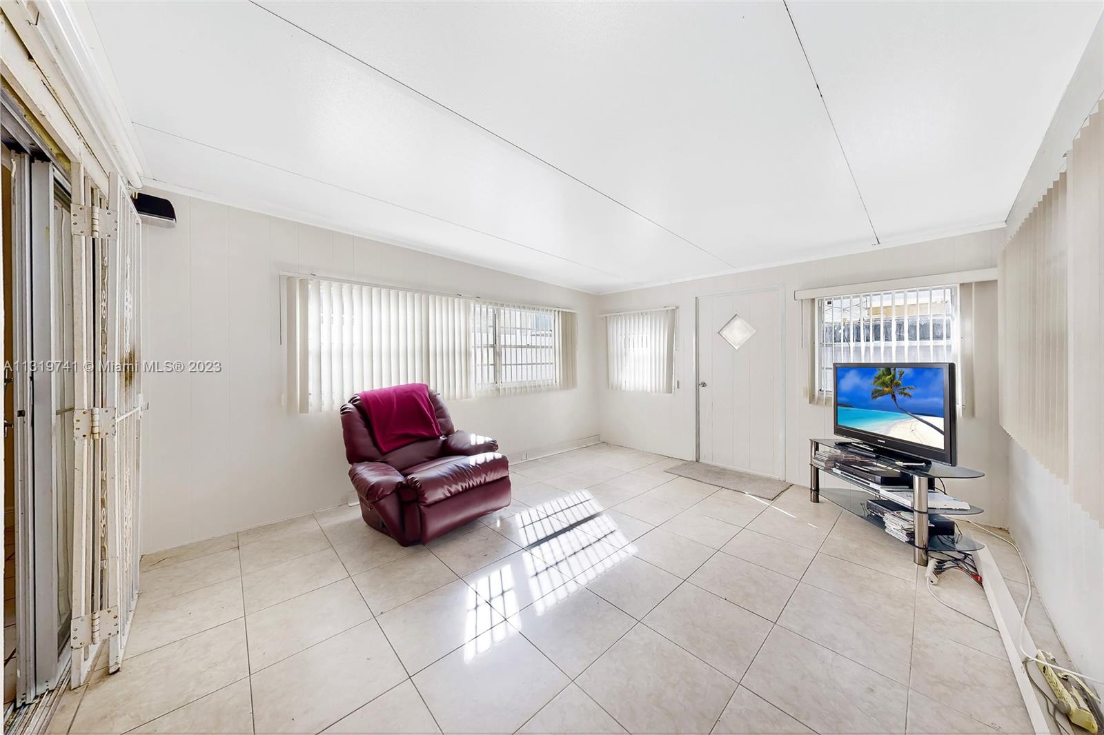 Hialeah Hialeah, FL 33014 - Photo 14 of 34 a living room with furniture gym equipment and a window