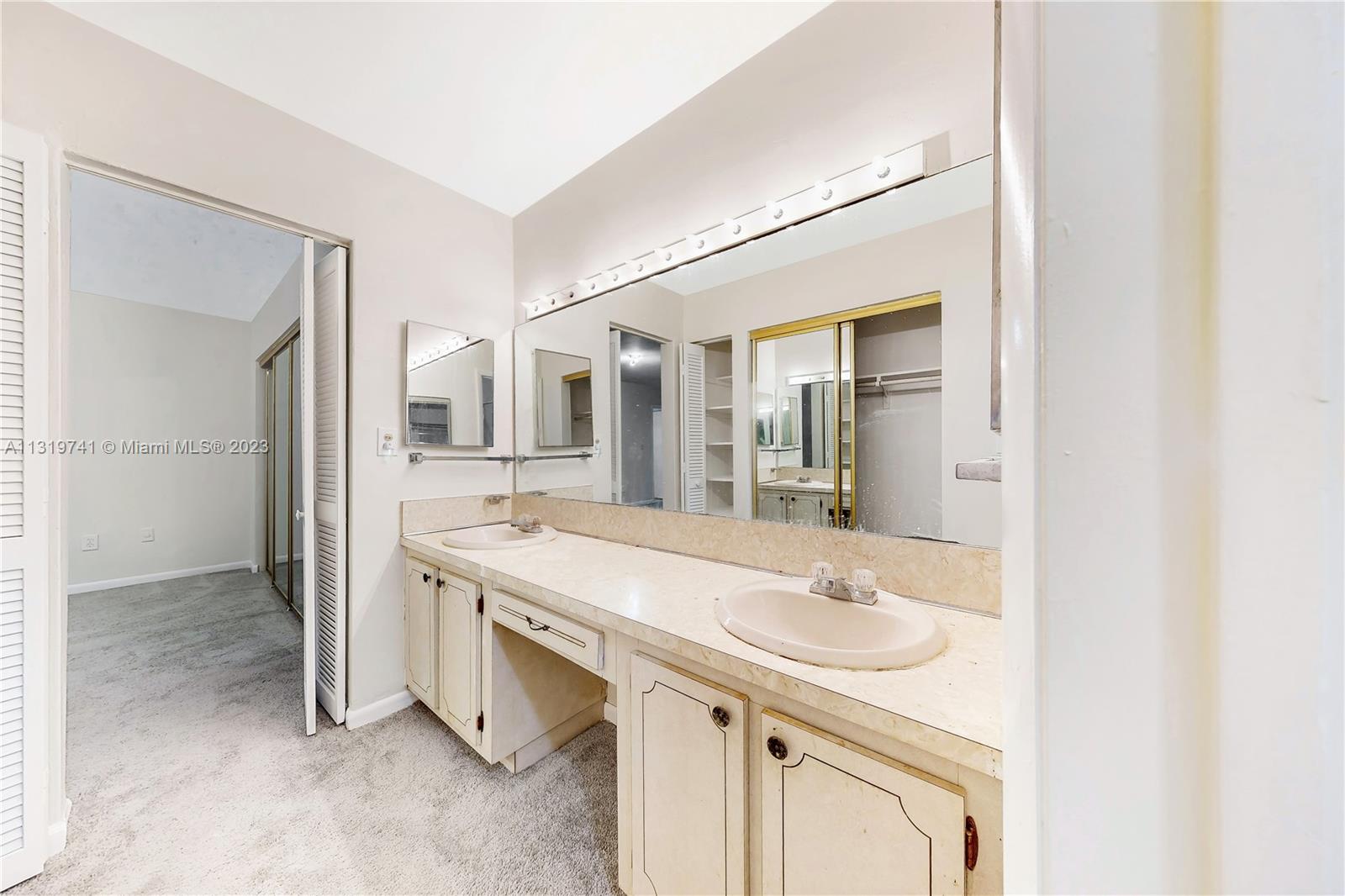 Hialeah Hialeah, FL 33014 - Photo 24 of 34 a spacious bathroom with a sink double vanity and a mirror