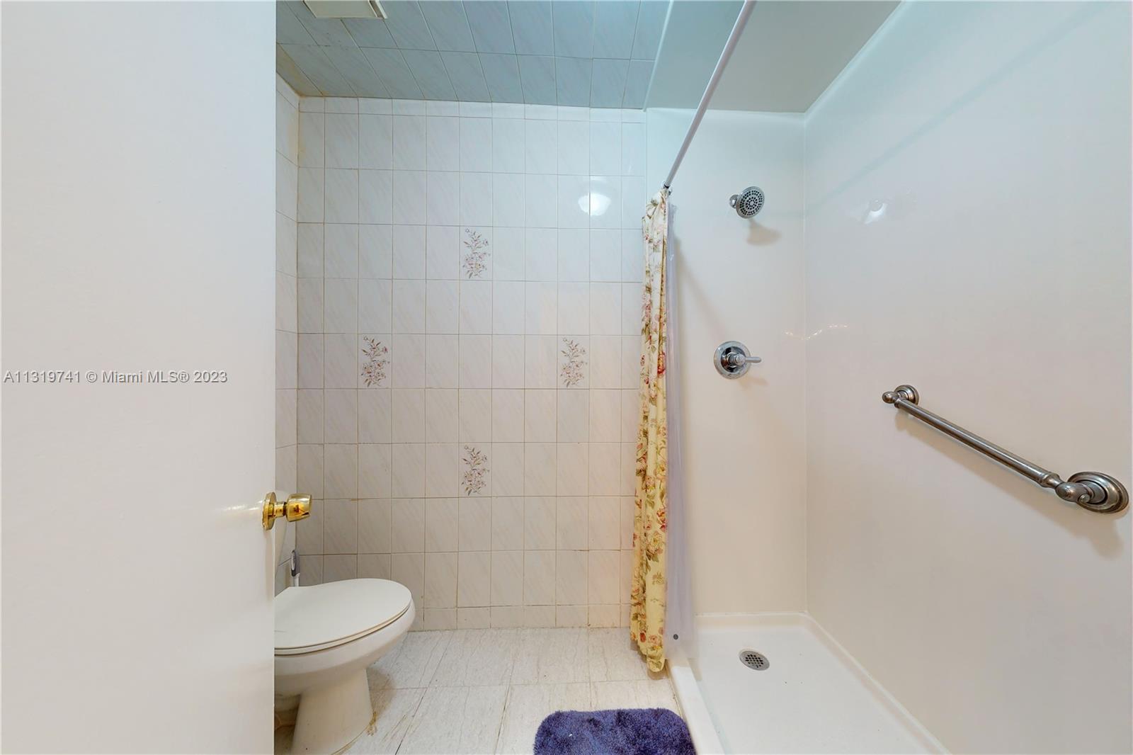 Hialeah Hialeah, FL 33014 - Photo 25 of 34 a bathroom with a shower a toilet and a sink