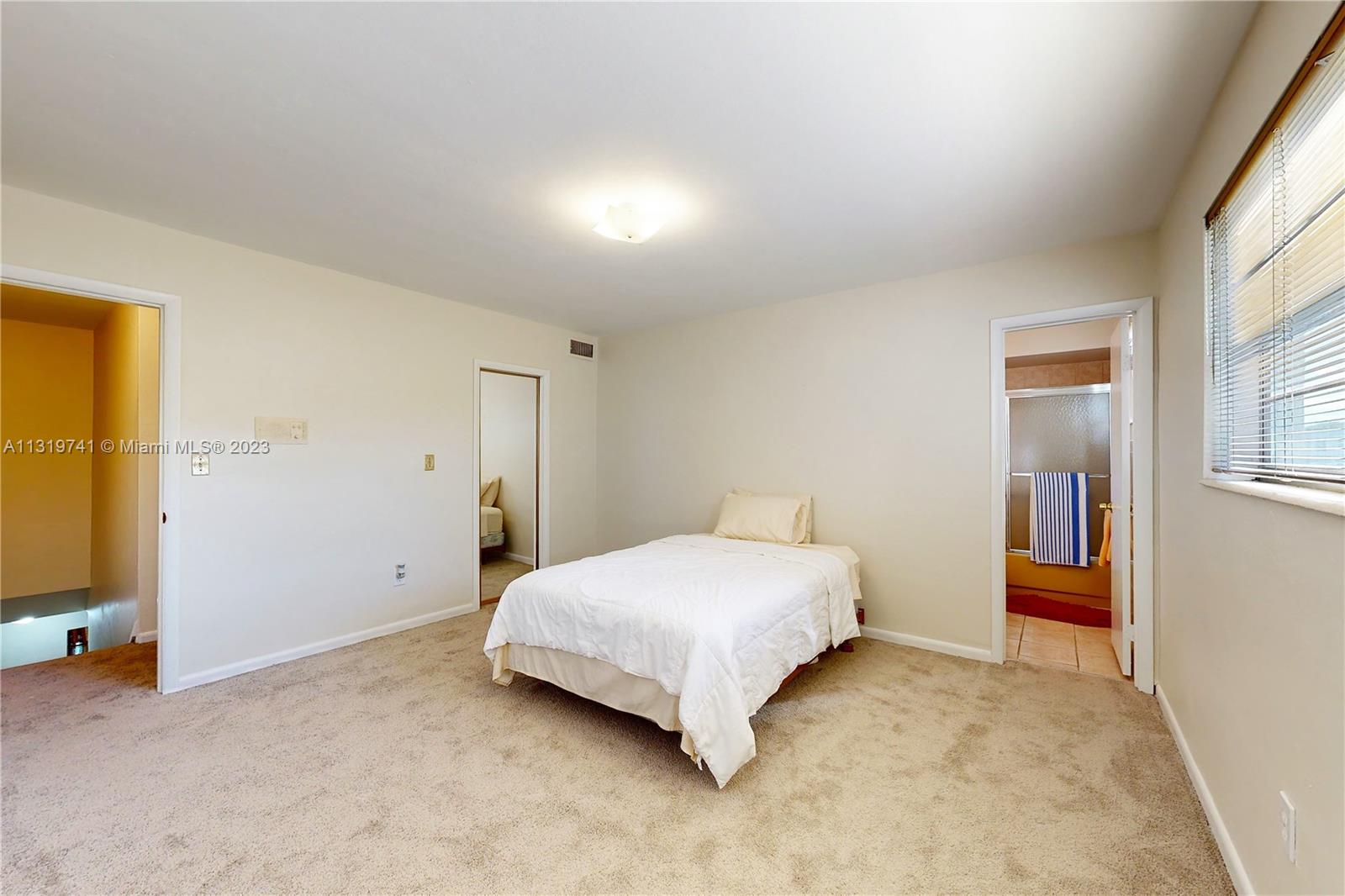 Hialeah Hialeah, FL 33014 - Photo 27 of 34 a bedroom with a bed and a cabinets