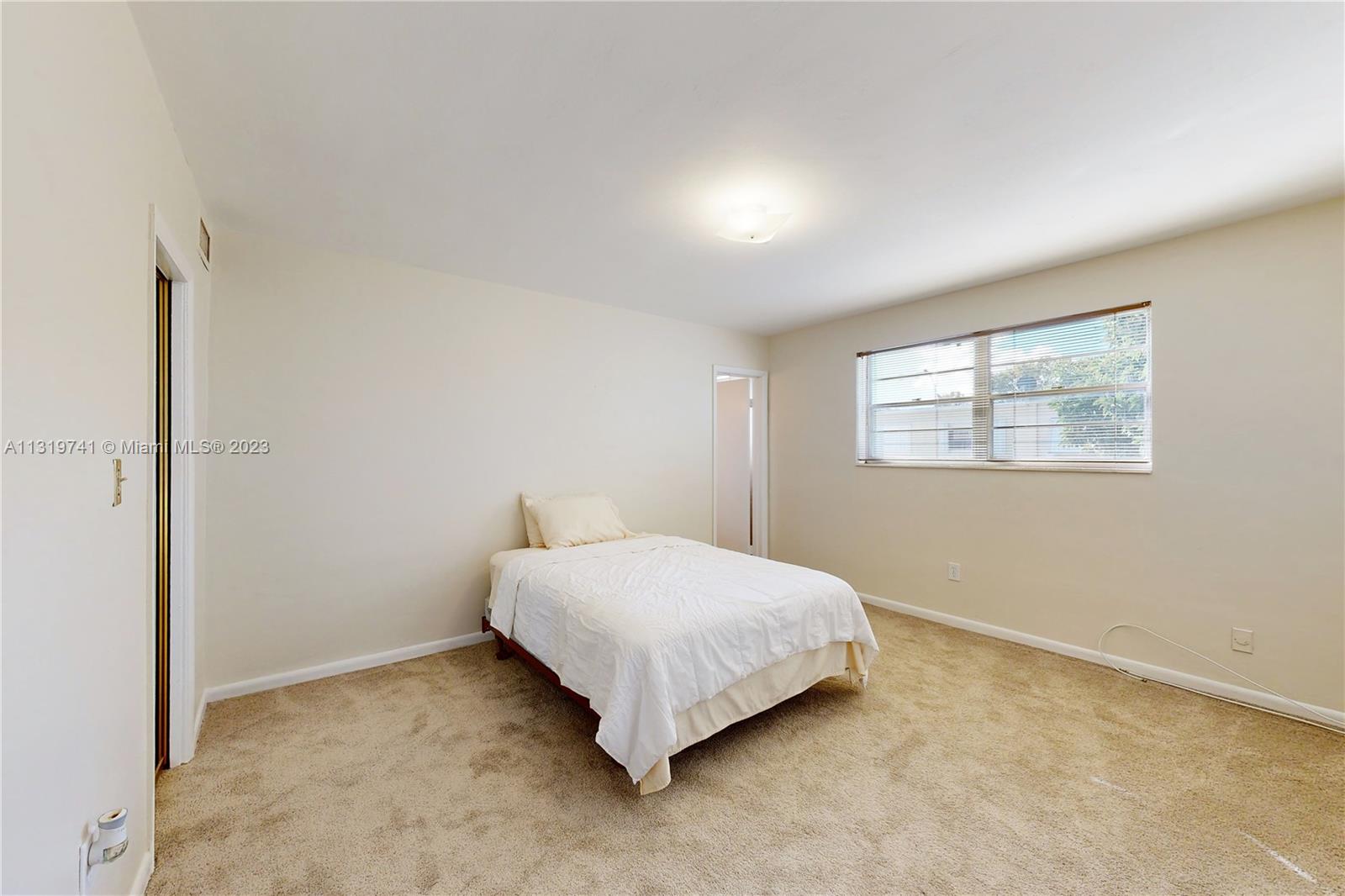 Hialeah Hialeah, FL 33014 - Photo 28 of 34 a bedroom with a bed and a window