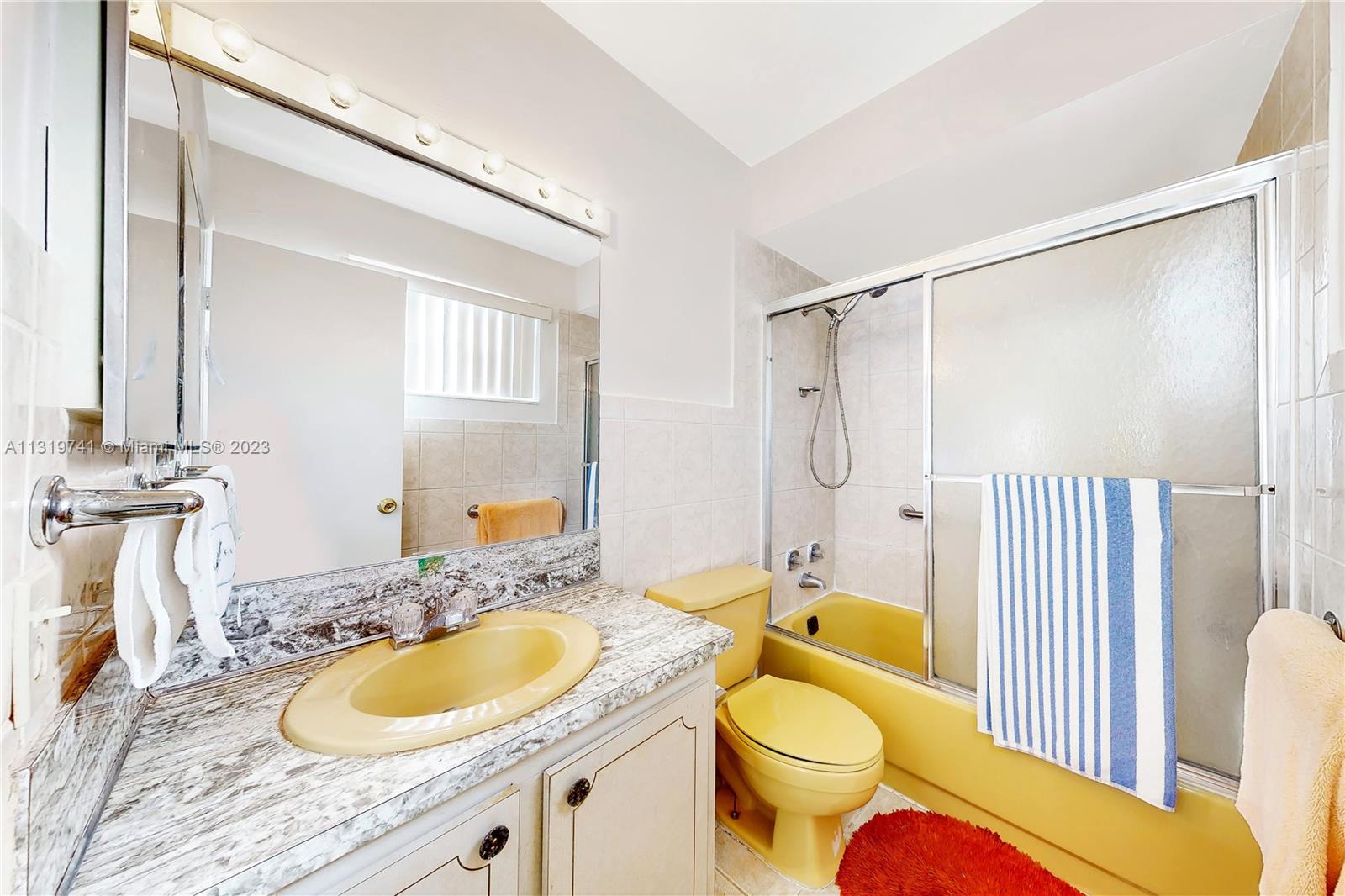 Hialeah Hialeah, FL 33014 - Photo 29 of 34 a bathroom with a granite countertop sink toilet and a mirror