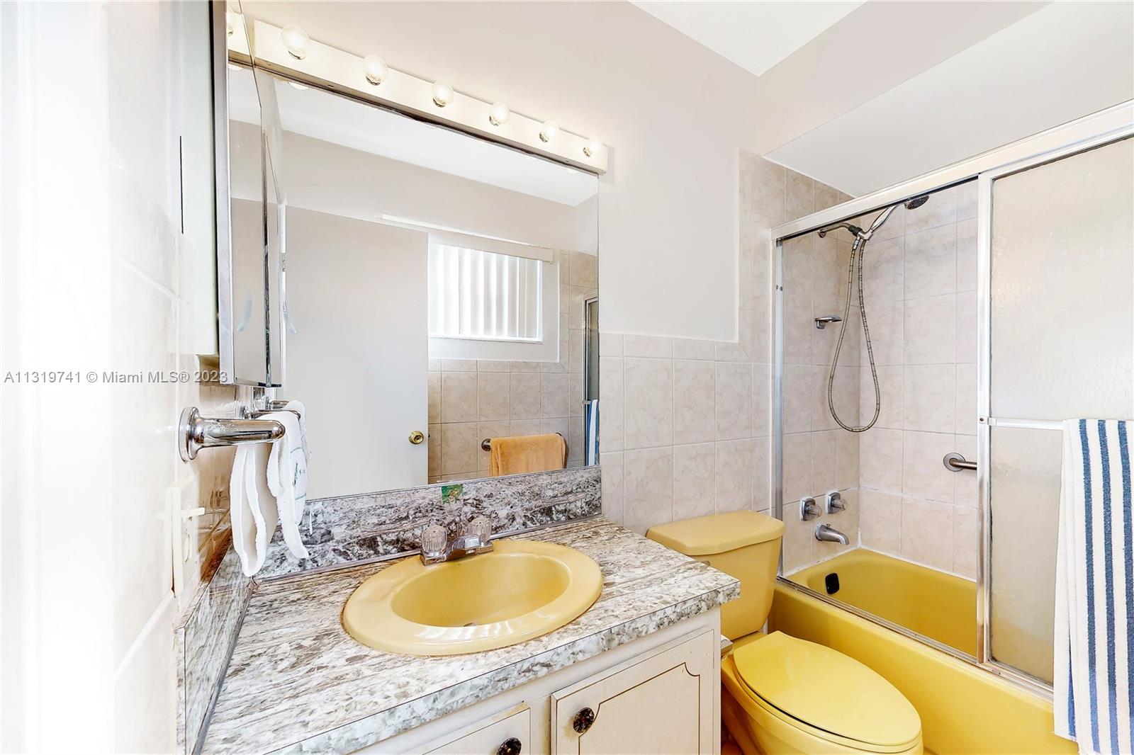 Hialeah Hialeah, FL 33014 - Photo 30 of 34 a bathroom with a granite countertop tub sink and mirror