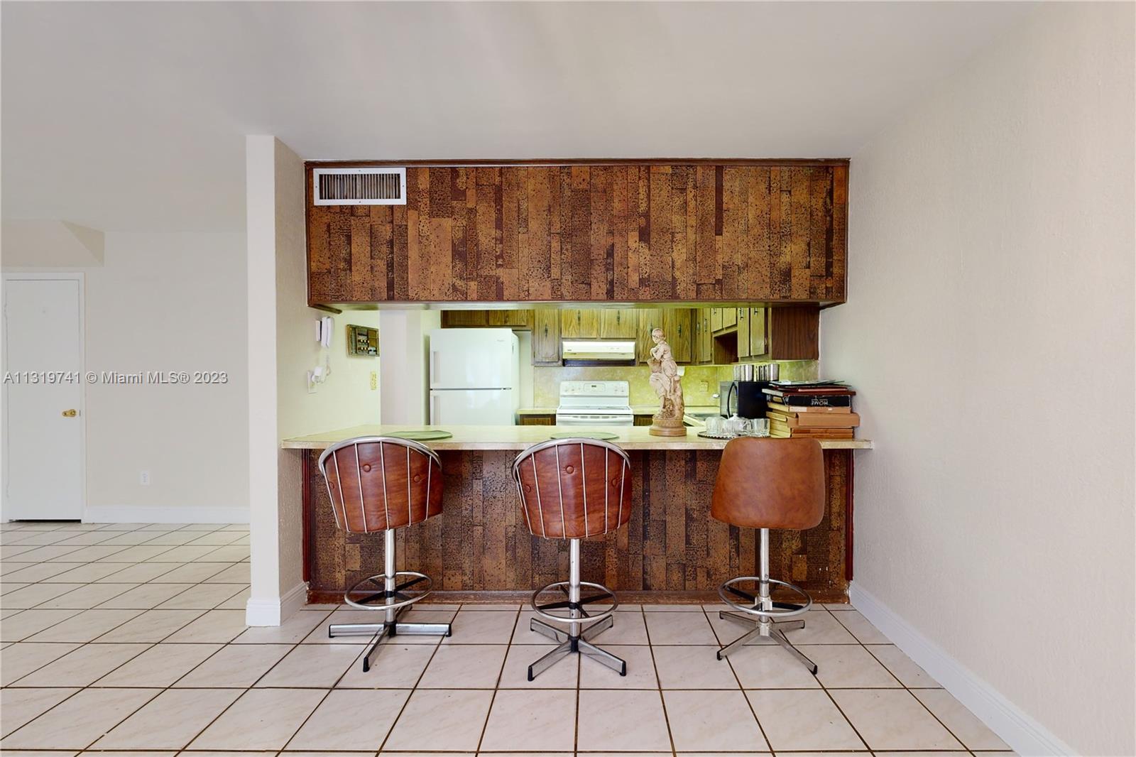 Hialeah Hialeah, FL 33014 - Photo 9 of 34 a room with a table and chair