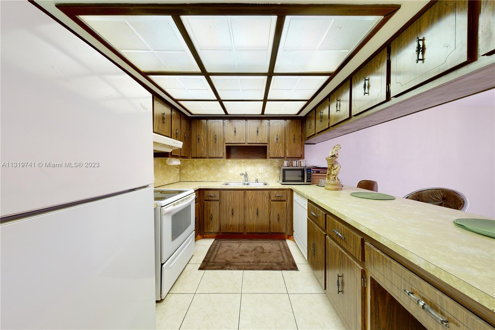Hialeah Hialeah, FL 33014 - Photo 10 of 34 a kitchen with a sink and cabinets