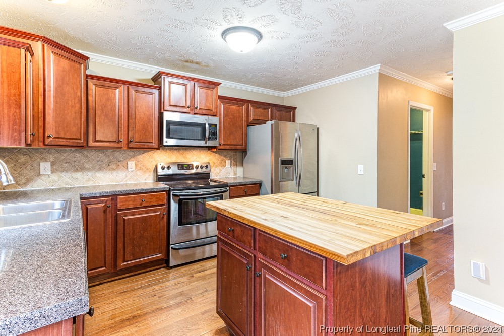 44 Ambrose Point Cameron, NC 28326 - Photo 14 of 48 a kitchen with stainless steel appliances granite countertop a refrigerator stove top oven and sink