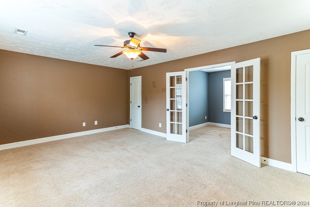 44 Ambrose Point Cameron, NC 28326 - Photo 37 of 48 an empty room with chandelier fan and windows