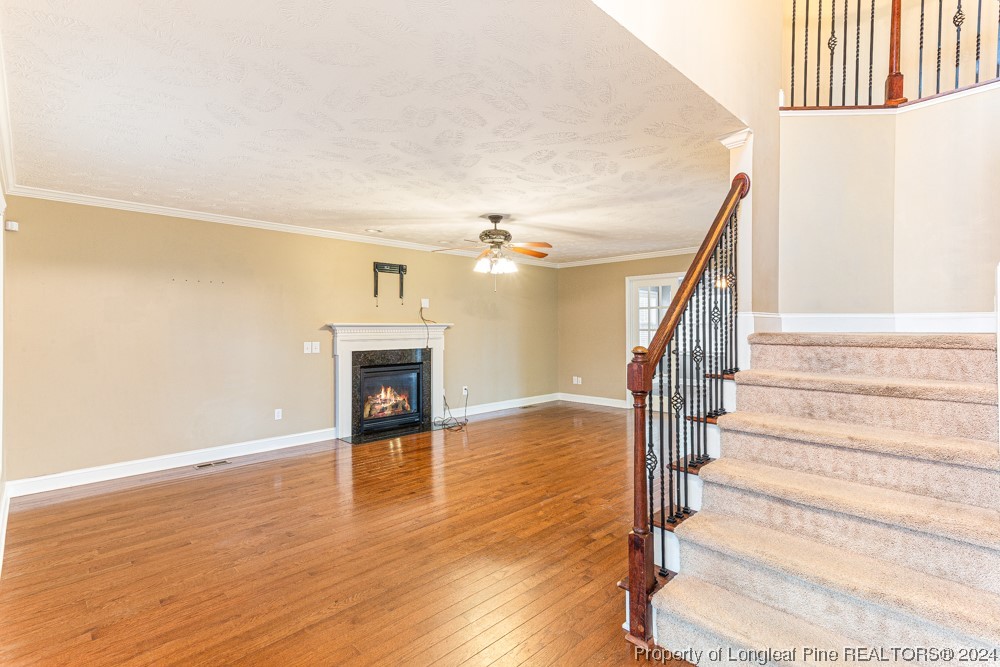 44 Ambrose Point Cameron, NC 28326 - Photo 4 of 48 a view of a livingroom with wooden floor and a ceiling fan