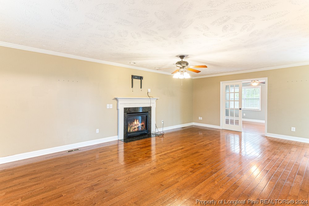 44 Ambrose Point Cameron, NC 28326 - Photo 5 of 48 a view of an empty room with wooden floor and a fireplace