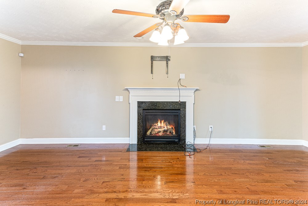 44 Ambrose Point Cameron, NC 28326 - Photo 7 of 48 a view of a livingroom with a fireplace a ceiling fan and wooden floor