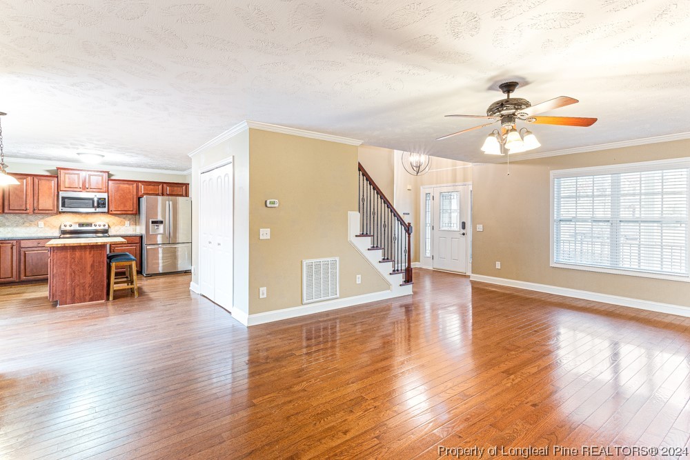 44 Ambrose Point Cameron, NC 28326 - Photo 8 of 48 a view of a livingroom with furniture a ceiling fan and wooden floor